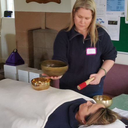 Carolyn generating healing sounds using beautiful Crystal singing bowls